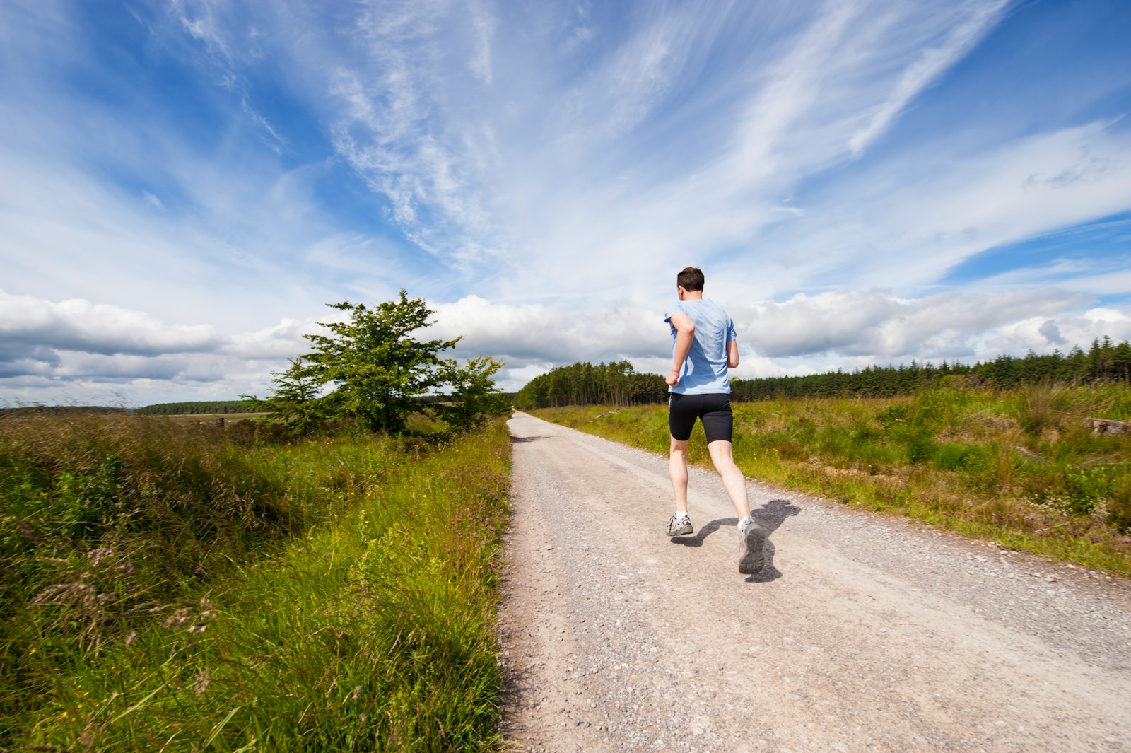 Photo by Jenny Hill - Aktivitus man running on road near grass field