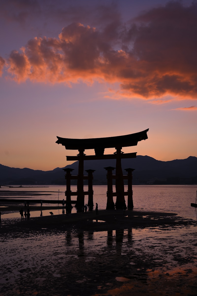 Photo by Marco DAbramo - Aktivitus Torii gate silhouette at sunset with clouds