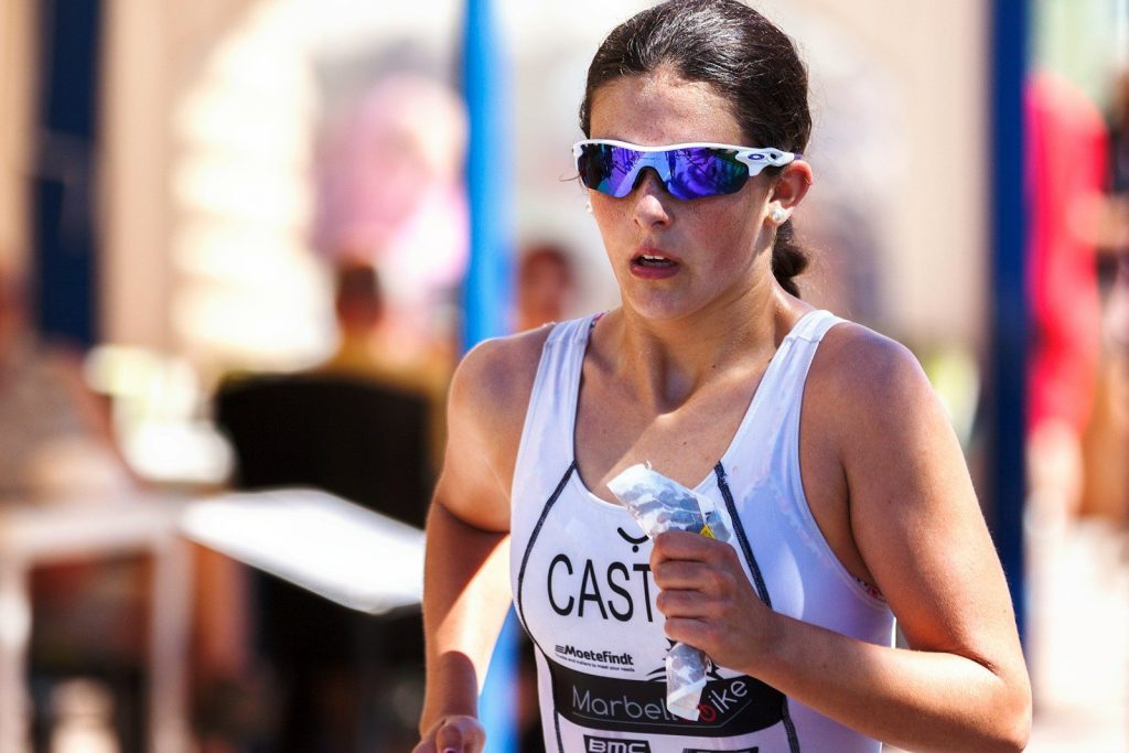Photo by Quino Al - Aktivitus woman wearing blue-lens sunglasses and white tank top